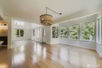 Dining room with walls of windows saturated in light