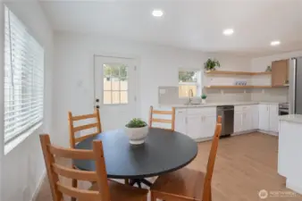 Dining space facing kitchen and back door