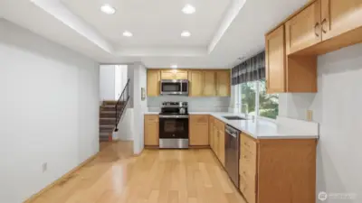 This kitchen is spacious and modern with all stainless steel appliances, quartz counters, and ample cabinet/storage space.