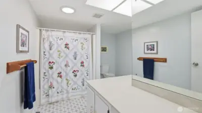 This upstairs full guest bathroom is huge and offers plenty of counter space!