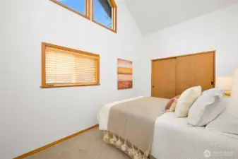 Primary bedroom features vaulted ceilings with lots of natural light.