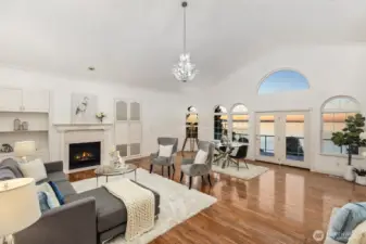 Soaring ceilings and arched windows frame breathtaking water views and evening light.