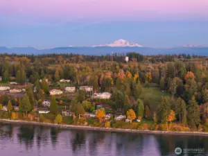 Snow-capped Mount Baker rises beyond the forested landscape and Semiahmoo Bay.