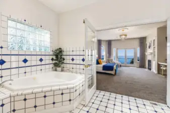French doors invite natural light and coastal views into your private bath.