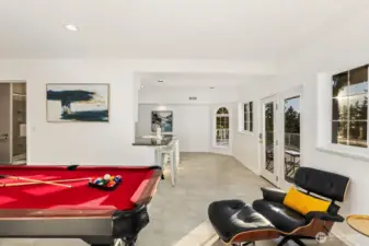 Host with ease or unwind in style—this light-filled lower level blends recreation and relaxation with effortless outdoor access.