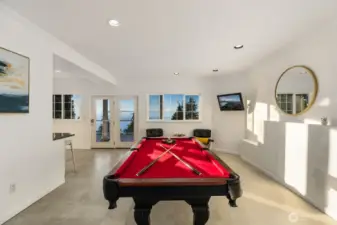 Space for billiards, media, or entertaining with ocean views as the backdrop.