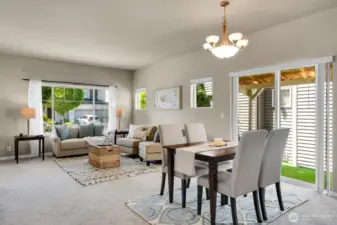 A beautiful light-filled living, dining, and kitchen area