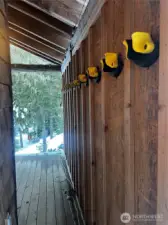 Covered front porch with 12 ski racks and room for 6 cords of wood