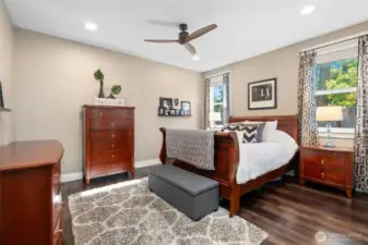 This main floor retreat doesn’t skimp on space or style. Big enough for a king bed and your favorite oversized dresser, it’s a room that works for real life. A modern 3-blade ceiling fan adds a sharp design detail, while two well-placed windows bring in soft natural light throughout the day.