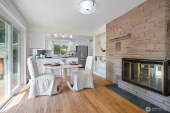 Dining area with decorative fireplace and side deck access