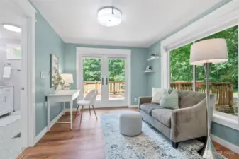 Primary sitting room with French doors to back deck