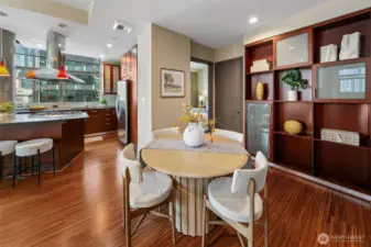 Dining area with built-in shelving flows easily between kitchen and living areas.