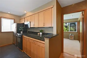 Kitchen and doorway to very large, newly carpeted bedroom.