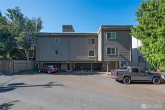 Back of building includes covered parking in carport. Space #4. Security door to the building to the left.
