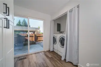 Beyond the laundry, sliding doors open to a second private patio.