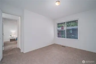 The two additional bedrooms upstairs also feature new closet doors, carpet, windows, blinds, and paint. This is one of them.