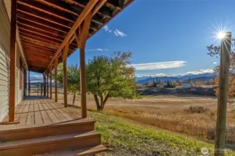 A covered porch runs the length of the home's west-facing facade