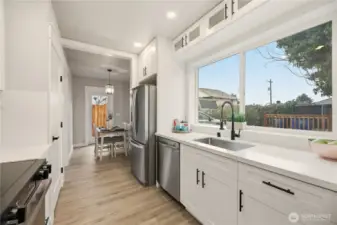 This amazing kitchen boasts a large window for natural light and has utilized every space. Notice the extra cabinets above the window?