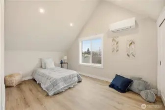 The first of two bedrooms on the second floor with vaulted ceilings and its own mini split heat pump. This room could accommodate a queen bedroom.