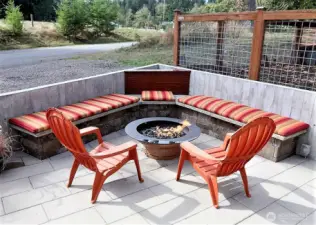Outdoor bench seating area with forged fire pit hard piped to propane.