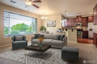 Huge windows pour light into the large living room that has a cozy fireplace!