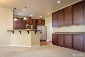 The buffet and upper cabinets between the dining and living room gives you storage for everything!