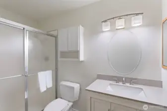 Primary 3/4 bath with newer vanity and quartz countertop. Freshly painted.