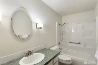 Main bathroom. Freshly painted, features soft vanity lights.