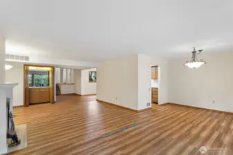 Closet wet-bar with sink and storage in open concept living room. Seller giving $15k credit at closing for new flooring.