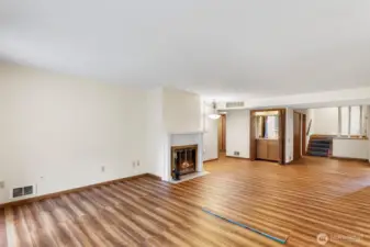 Another view of all of this space and the classy wood burning fireplace.