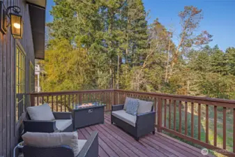 Private outdoor deck surrounded by trees offers the perfect place to relax, entertain, or enjoy morning coffee while overlooking peaceful Pacific Northwest forest views.