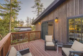 Spacious deck with comfortable seating and wooded surroundings creates a quiet retreat, offering a true “treehouse” experience backing the University of Washington Preserve.