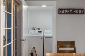Convenient laundry closet with full-size washer and dryer located near the main living areas for everyday ease.