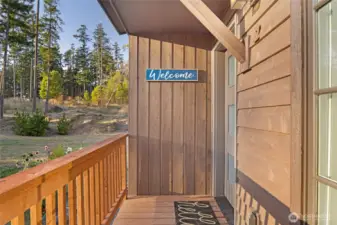 Welcoming entry deck with charming covered entry and wood siding, setting the tone for this stylish and well-maintained Friday Harbor condo residence.