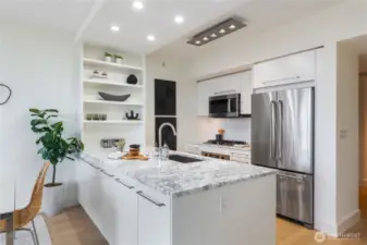 Carrara marble countertops. Stainless steel appliances. Beautiful backsplash.