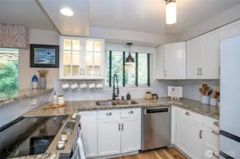 Solid countertops and accent cabinetry enhance this inviting space, making it perfect for meal preparation and everyday living.