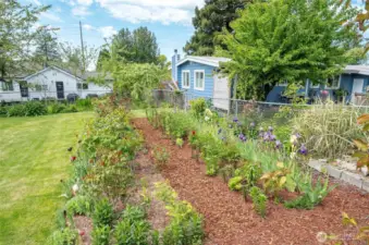 The vibrant cutting garden features roses, peonies, irises, lilies, tulips, and more—offering continuous blooms from March through November.