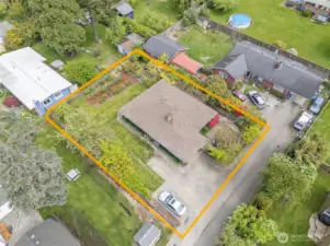 The aerial view showcases the meticulously maintained home and landscape, with generous parking for vehicles, guests, or recreational needs.