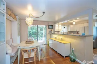 The spacious dining area, adjacent to the kitchen, features an eating bar and a sliding door that opens to a patio with arbor-covered pathways leading to the backyard. In the opposite direction, another patio awaits—graced with arbors draped in grapevines, perfect for relaxing or entertaining.