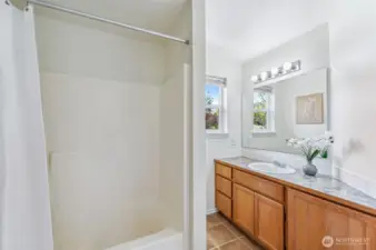 Guest bathroom upstairs is light and airy.