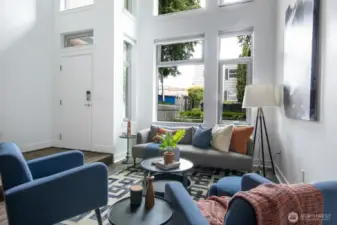 Floor-to-ceiling windows fill the space with natural light.