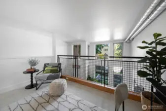 Overhead view of the main space highlights the airy, open-concept layout with industrial touches.