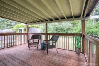 Covered back deck with room for BBQ and outdoor dining