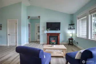 Open living room with high ceilings and electric fireplace