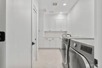 Laundry room full of storage options.