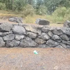 Rock wall separates upper and lower levels of lot.