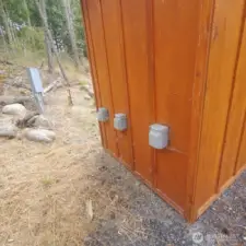 3 separate 50 AMP service plugs installed on back of pump house for up to 3 RV's or trailer to power.