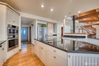 THE ISLAND COOK TOP IS ALMOST INVISIBLE AGAINST THE BLACK GRANITE COUNTERS!