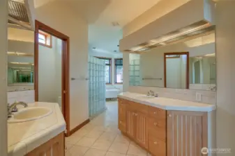THE LARGE BATHROOM HAS HIS AND HERS TILED SINKS WITH RECESSED LIGHTING! THE EASY CARE TILED FLOORS MAKE THE ROOM LOOK EVEN LARGER! BEHIND THE GLASSED WALL IS THE SHOWER AND THEN SOAKING TUB!