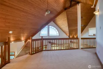 THE HALLWAY IS GORGEOUS WITH THE HARDWOOD CATHEDRAL CEILINGS AND THE HALF MOON WINDOW SHOWING OFF THE BAY VIEW!